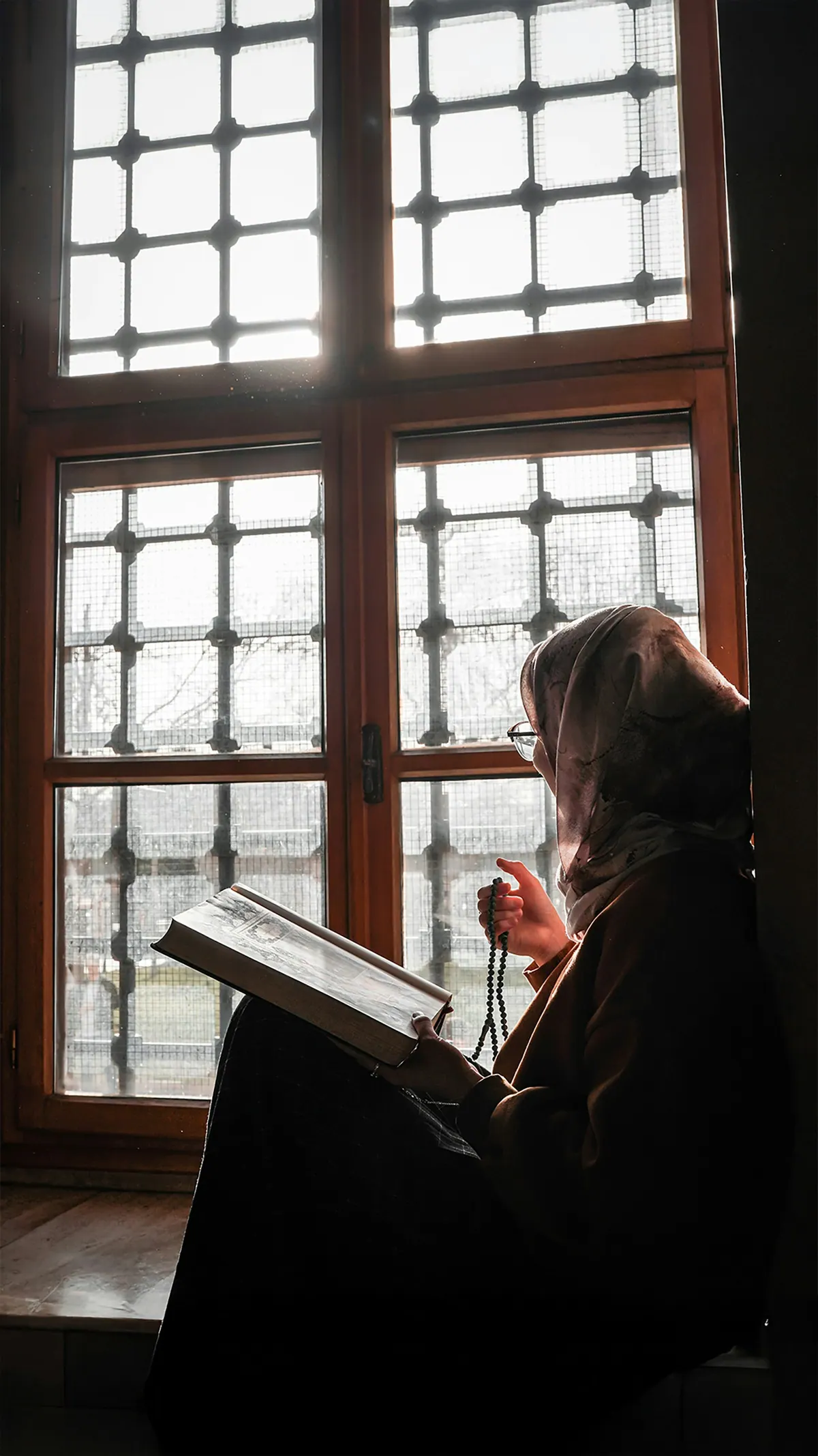 Woman reading for the Quran and Tajweed course